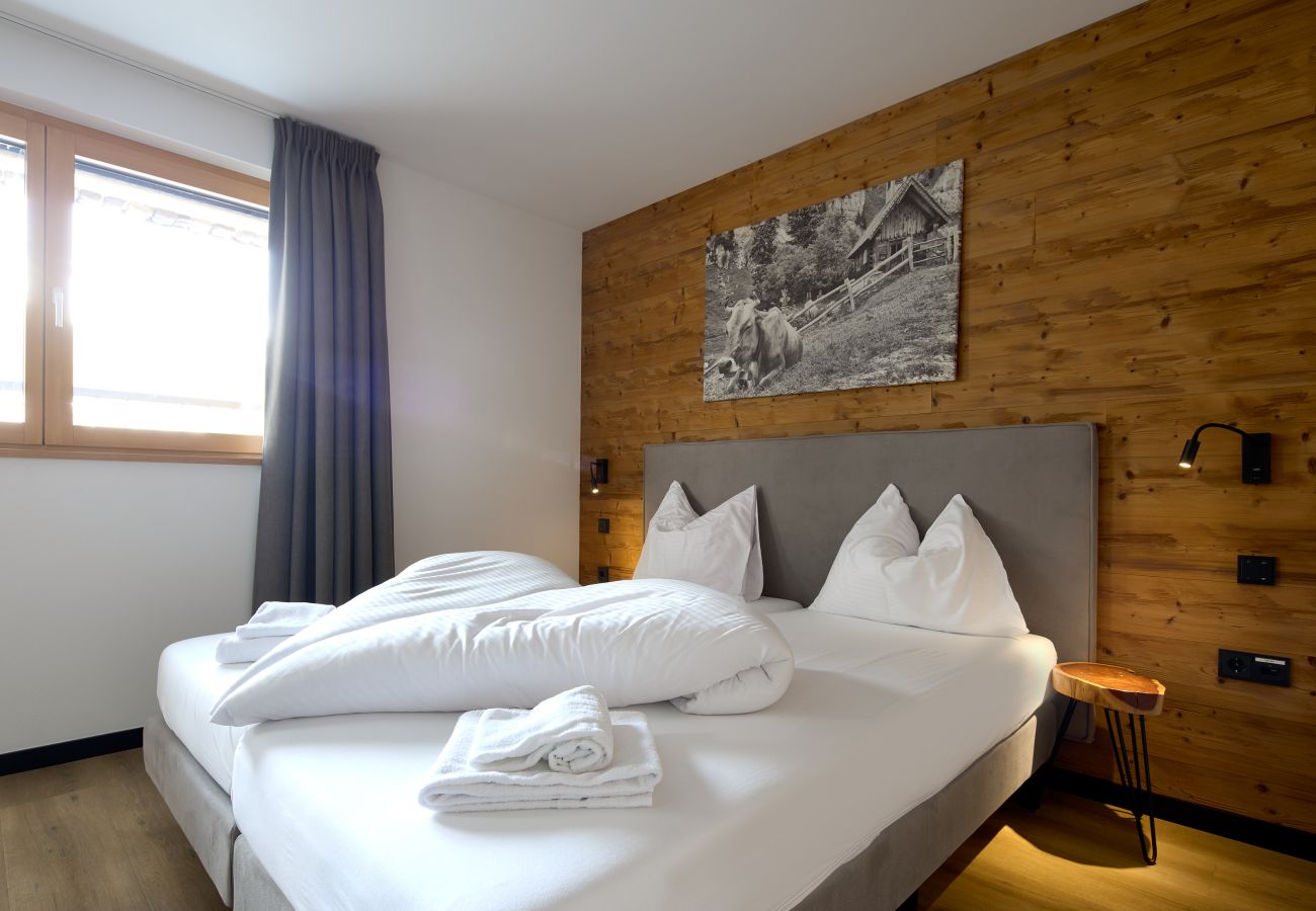 Slaapkamer Alpen-Dohle 202 Alpin-Resort Montafon Slaapkamer met tweepersoonsbed in Alpen-Dohle 202 Alpin-Resort Montafon