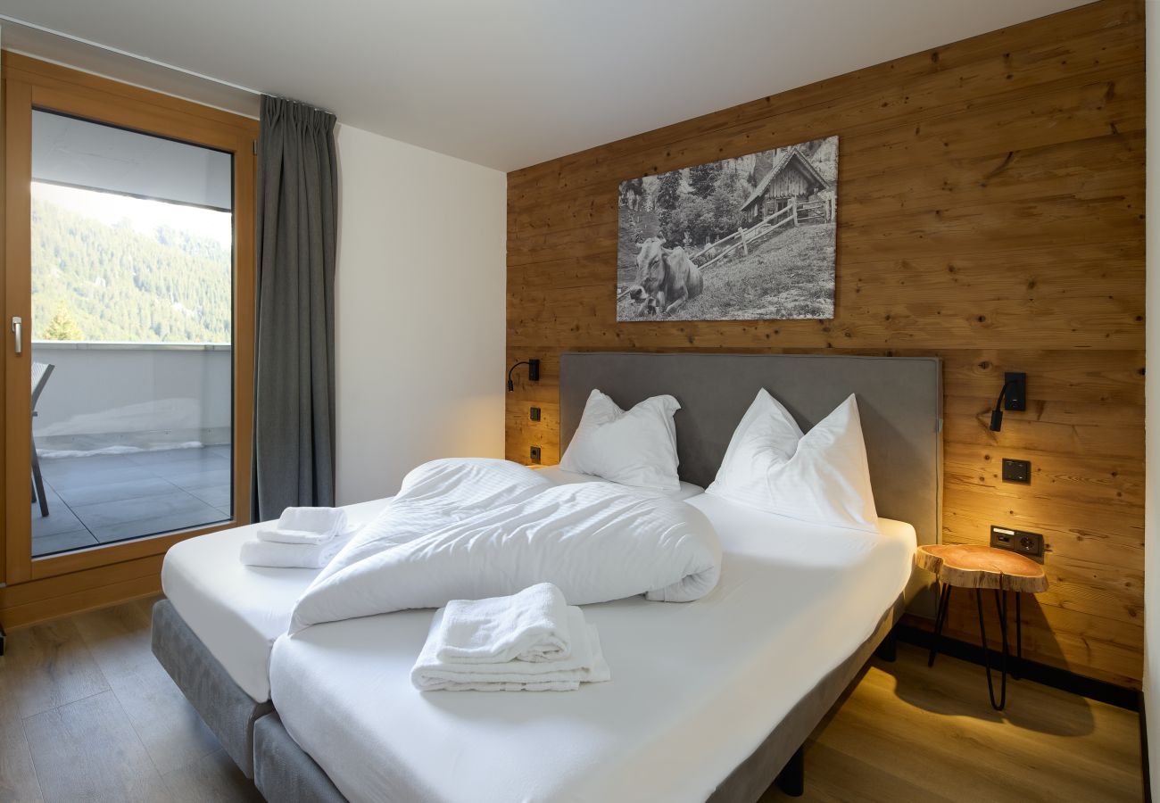 Slaapkamer met tweepersoonsbed in Alpen-Krähe 317 Alpin-Resort Montafon