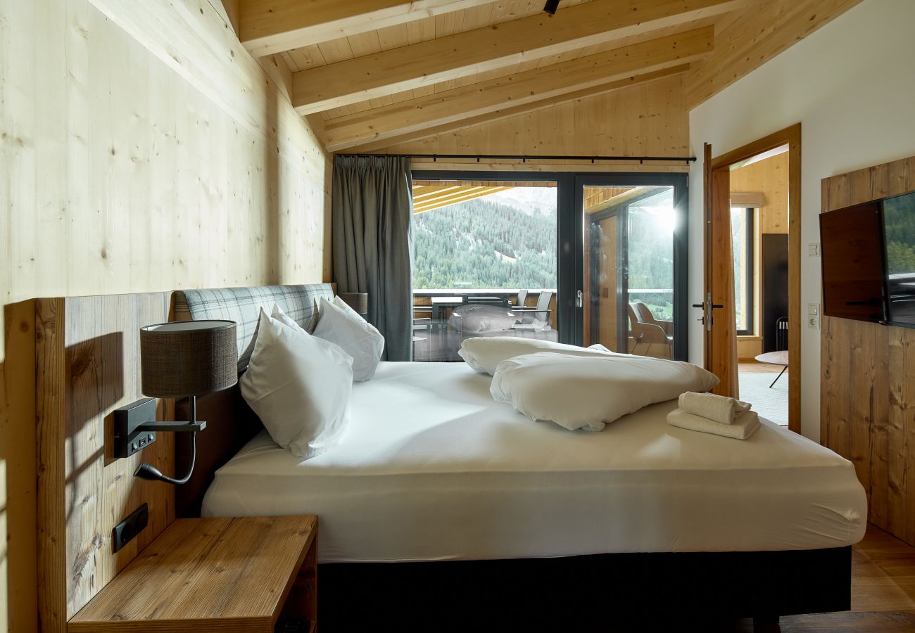 Bedroom Alm Lodge 1 Double bed with TV and beautiful view in Alm Lodge 1