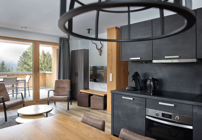 Living room Bartgeier 111 Alpin-Resort Montafon Living area with kitchen and table in the Bartgeier 111 Alpin-Resort Montafon