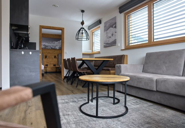 Living room Bartgeier 111 Alpin-Resort Montafon Living area with sofa and table in the Bartgeier 111 Alpin-Resort Montafon