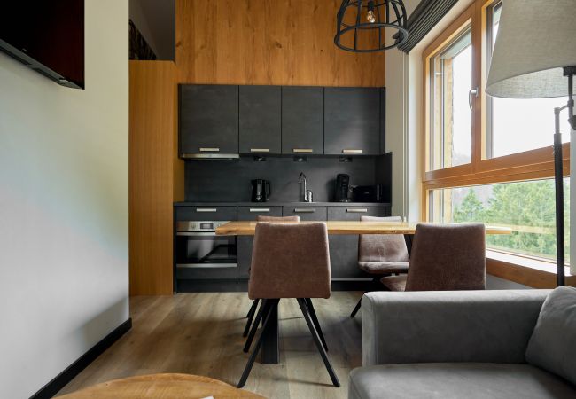 Living room Bartgeier 119 Alpin-Resort Montafon Living area with kitchen and table in the Bartgeier 119 Alpin-Resort Montafon