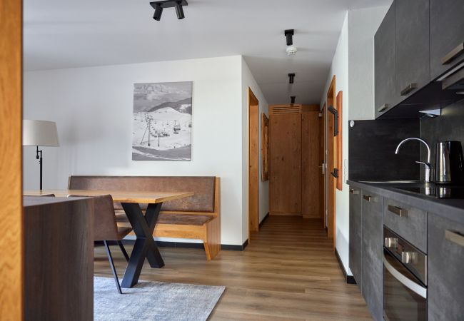 Living area with kitchen and table in the Alpen-Krähe 312 Alpin-Resort Montafon
