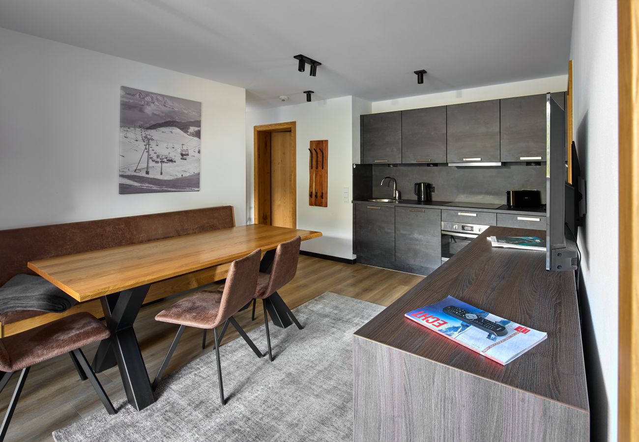 Living area with kitchen and table in the Alpen-Krähe 317 Alpin-Resort Montafon
